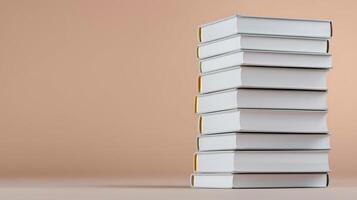 A neatly stacked arrangement of blank books against a soft, neutral background photo