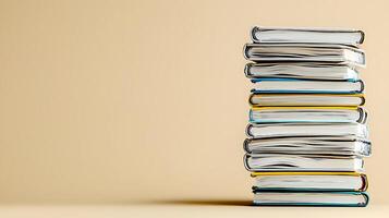 A neatly stacked pile of books on a soft beige background, suggesting study and knowledge photo