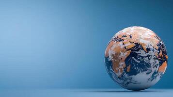 A realistic globe showcasing continents and oceans against a minimalist blue background photo