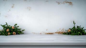 A serene tabletop scene featuring lush greenery and soft roses against a textured white wall photo