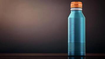 A sleek blue aluminum water bottle with an orange cap, set against a dark, gradient background photo