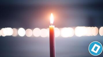 A solitary candle flame illuminates a dimly lit background with blurred lights, creating a serene ambiance photo