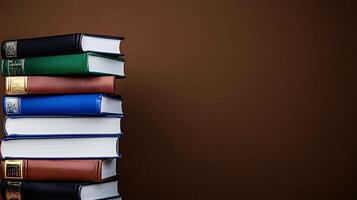 A stack of colorful hardcover books arranged neatly against a brown background, ideal for educational themes photo