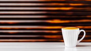 A steaming cup of coffee on a sleek table with a blurred warm background of horizontal lines photo