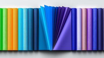 A vibrant array of fabric rolls arranged in a gradient from green to blue, showcasing texture and color photo