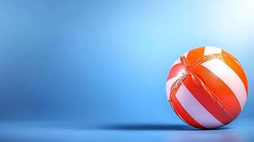 A vibrant striped beach ball rolling on a smooth blue surface with soft lighting photo