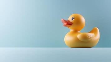 A vibrant yellow rubber duck on a soft blue background, evoking a playful and cheerful atmosphere photo