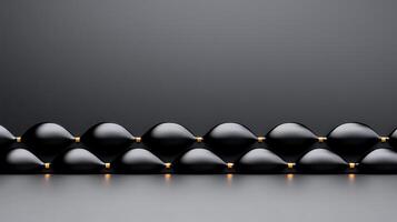 Abstract arrangement of glossy black shapes creating a wave-like pattern on a minimalist background photo
