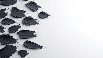 Abstract black paint strokes artistically arranged on a white background for creative design use photo