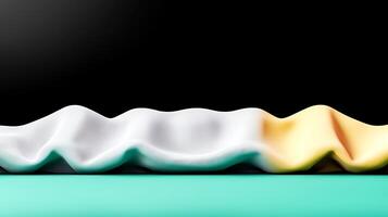 Abstract composition of draped fabric in white, yellow, and teal against a black background photo