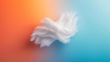 Abstract composition of white wispy texture against a vibrant orange and blue gradient background photo