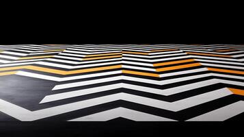 Abstract pattern of black, white, and orange zigzag lines on a floor with a dark background photo