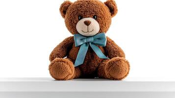 Adorable brown teddy bear with a blue bow sitting on a white shelf against a minimalistic background photo