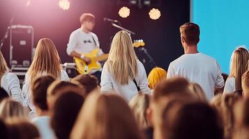 Audience enjoying a live music performance at an outdoor concert with vibrant lighting photo