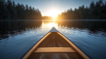 Canoe gliding through tranquil waters at sunset, surrounded by lush forest, creating serenity photo