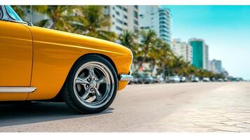 Classic yellow car parked on a sunny street with palm trees and modern buildings in the background photo
