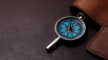 Close-up of a compass on a brown leather surface, symbolizing navigation and exploration themes photo