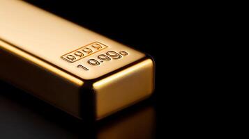 Close-up of a shiny gold bar with detailed engravings on a black reflective surface photo