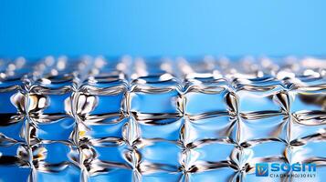 Close-up of a reflective surface with water droplets and a blue background creating a serene effect photo