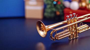 Close-up of a shiny golden trumpet on a dark surface with festive decorations in the background photo