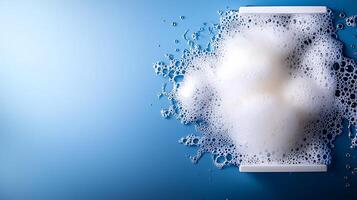 Close-up of a soapy foam texture on a blue background, suggesting cleanliness and freshness photo