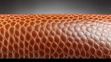 Close-up of a textured brown leather surface showcasing intricate patterns and shine photo