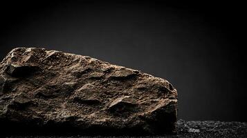 Close-up of a textured rock on a dark surface with a blurred background highlighting its features photo