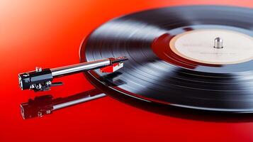 Close-up of a vinyl record spinning on a turntable against a vibrant red background photo