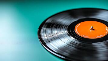 Close-up of a vinyl record on a teal background, showcasing its grooves and label details photo