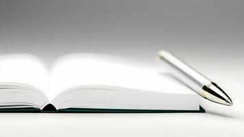 Close-up of an open book with a silver pen resting beside it on a smooth, gradient background photo