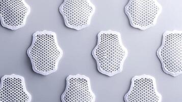 Close-up of intricate white lace patterns arranged symmetrically on a light background photo