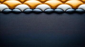 Close-up of textured fabric with golden, white, and blue patterns against a dark background photo