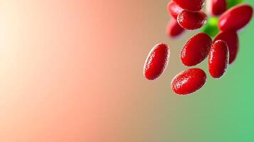 Close-up of vibrant red berries hanging from a green branch against a soft gradient background photo