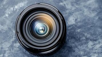 Close-up view of a camera lens showcasing intricate details and reflections against a textured backdrop photo