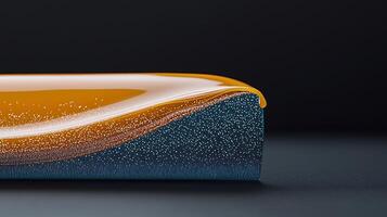 Close-up view of a glossy orange and blue fluid wave on a dark background, creating a vibrant contrast photo