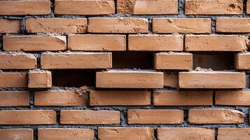 Close-up view of a textured brick wall with missing bricks, revealing underlying structure photo
