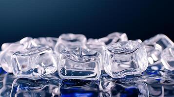 Close-up view of clear ice cubes on a reflective surface with a dark blue background, ideal for beverage themes photo