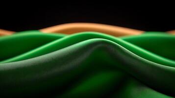 Close-up view of flowing fabric waves in vibrant green and orange colors against a dark background photo