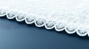 Close-up view of intricate lace fabric edge on a smooth surface, showcasing delicate design details photo