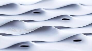 Close-up view of textured white fabric with undulating waves and circular cutouts, creating depth photo