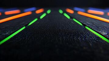 Close-up view of vibrant neon lines on a textured black surface, creating a dynamic visual effect photo