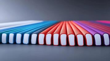 Colorful array of notebooks arranged in a gradient pattern on a sleek surface, creating an appealing backdrop photo