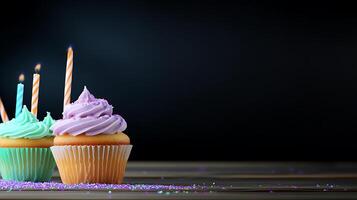 Colorful cupcakes with candles on a wooden table, set against a dark background for celebration photo