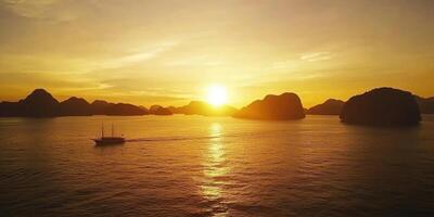 A boat is sailing in the ocean at sunset photo