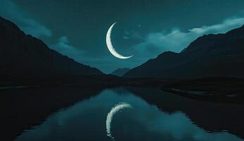 A crescent moon is reflected in the water photo