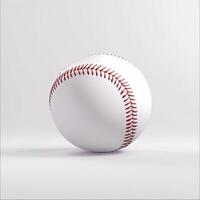 A baseball, white with red stitching, sits on a plain white background photo