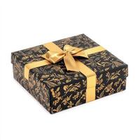 Elegant gift box with gold ribbon and floral design photo
