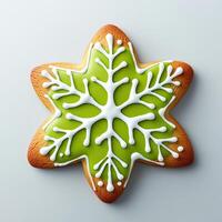 Festive star-shaped cookie with green icing snowflake design photo