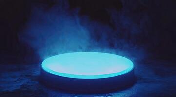 Circular stage lit with vibrant blue light, surrounded by smoky haze photo