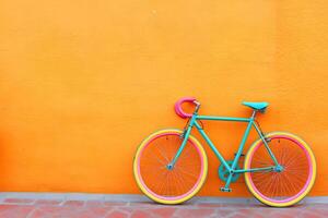 Vibrant bicycle against a bold orange wall photo